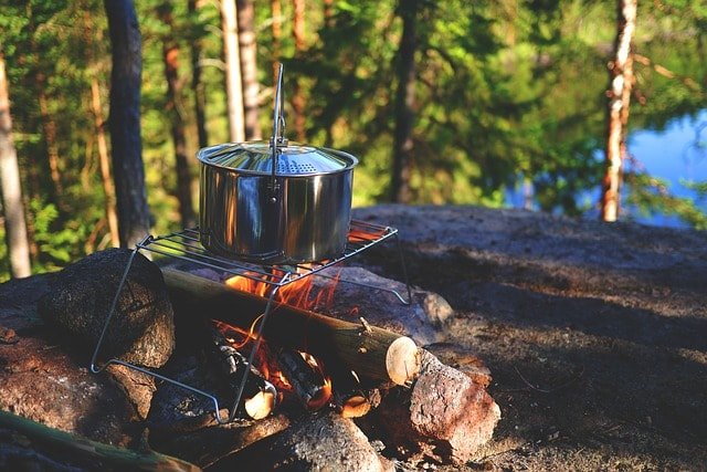 A campfire and tents set up for a night outdoors