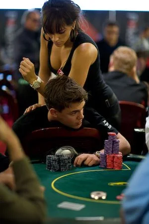 A massage therapist working on a player during a poker night
