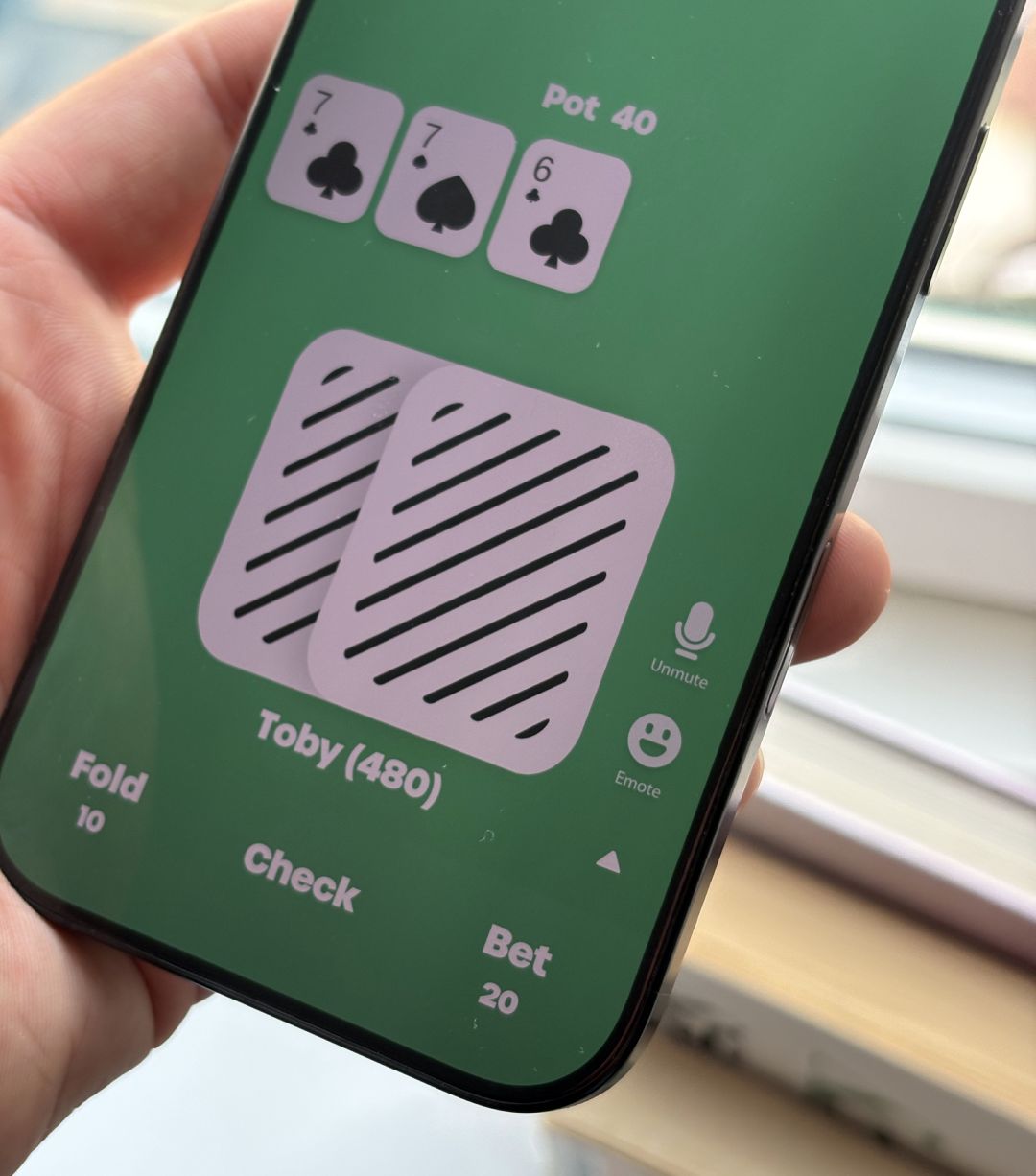 A poker hand in EasyPoker with the Unmute button for voice chat beside the cards