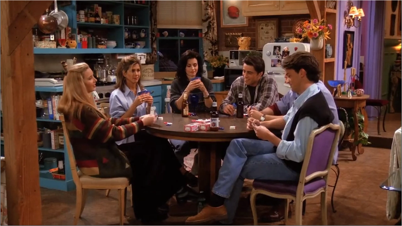 Friends learning poker together around a table at a relaxed home game
