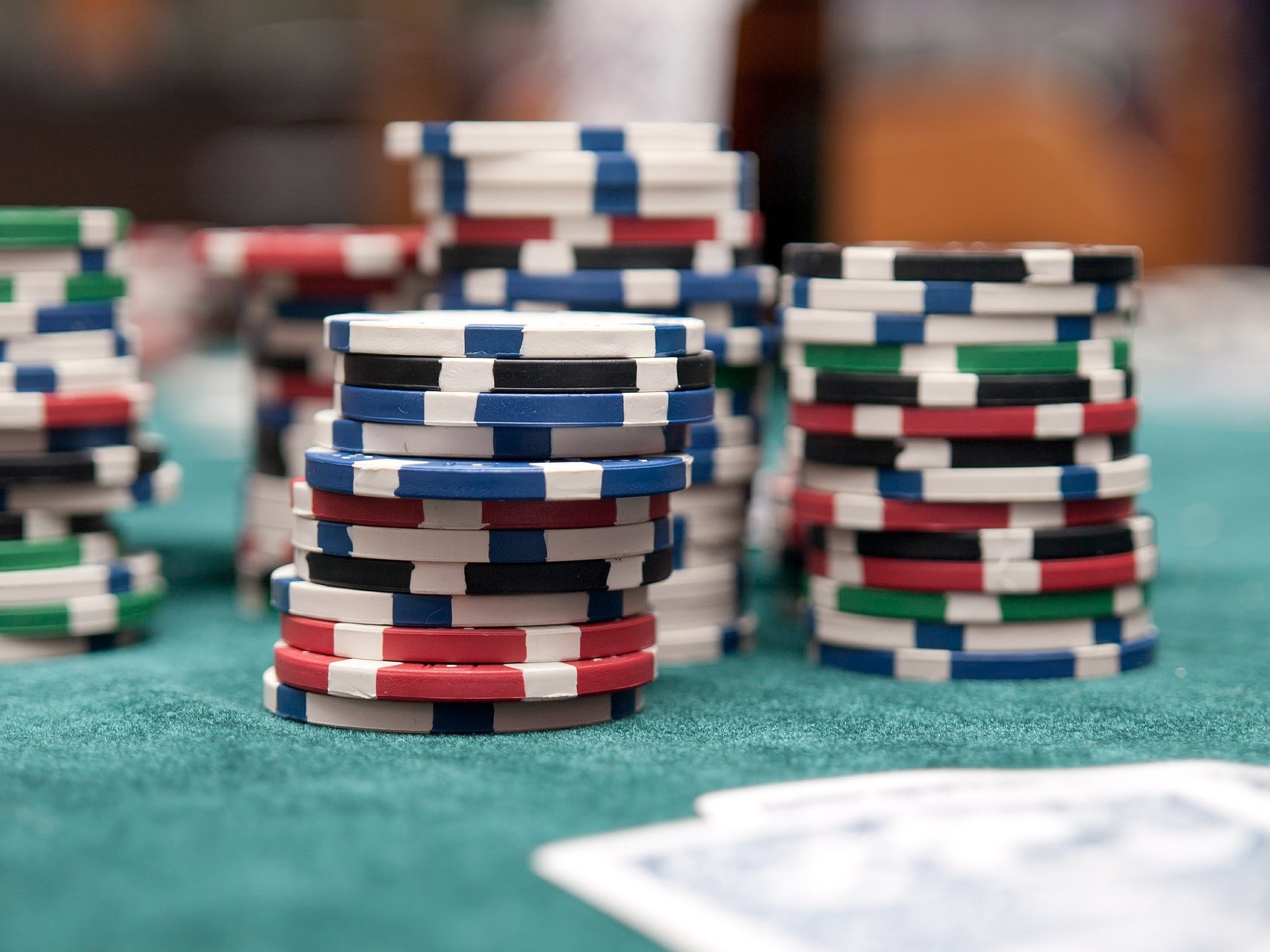 Stacks of poker chips on a green poker table
