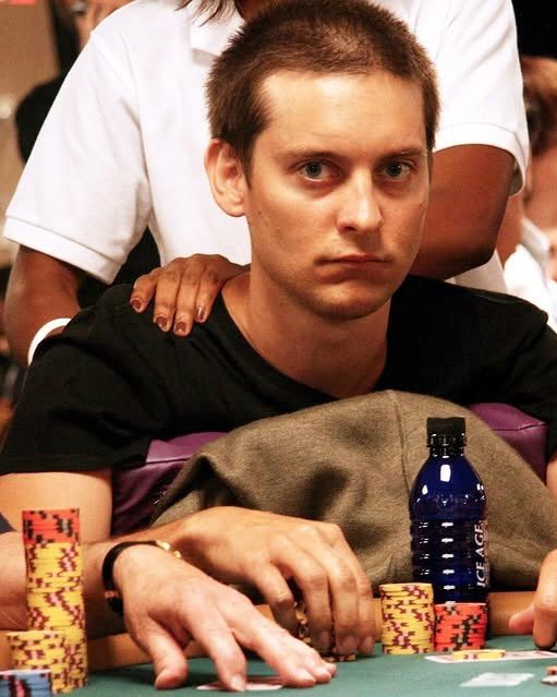 Tobey Maguire sitting behind a stack of chips at a poker table