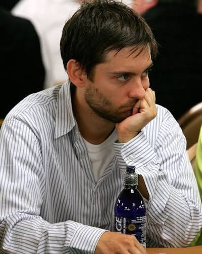 Tobey Maguire studying the table during a live poker tournament